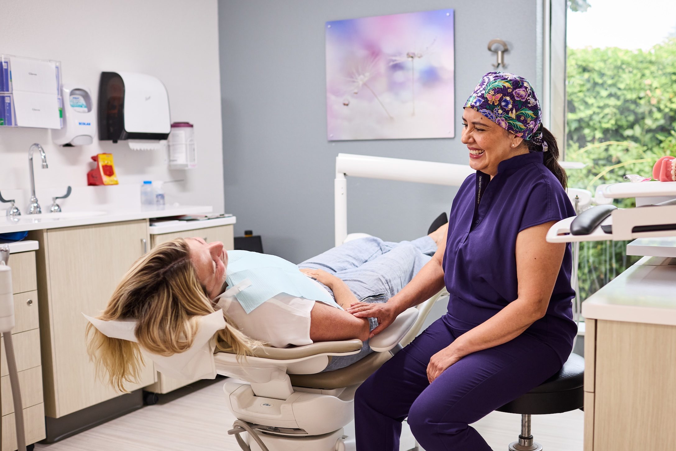 dentist smiling and listening to a patient